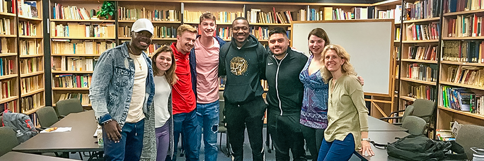 Group photo of students in a library