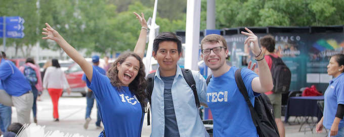 Three happy students posing in a street in Mexico.